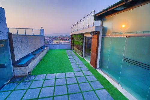 an empty balcony of a building with a green lawn at Hotel Holy Vivasa in Rishīkesh