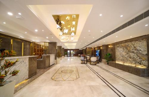 a lobby of a hotel with a chandelier at Hotel Holy Vivasa in Rishīkesh