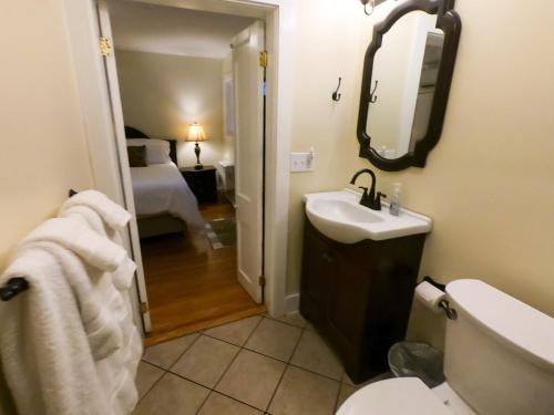 ein Bad mit einem Waschbecken, einem WC und einem Bett in der Unterkunft Villa Mulvey #2 in St. Augustine