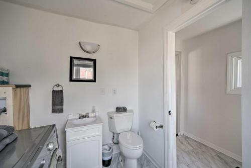 a white bathroom with a toilet and a sink at Trendy Superior Home Perfect for Groups! in Superior