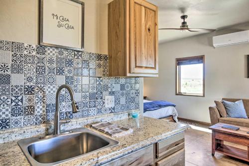 a kitchen with a sink and a living room at Cozy Elgin Casita with Gas Grill Pets Welcome! in Elgin