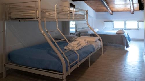 a bedroom with two bunk beds in a room at Pepi B&B in Santa Maria di Castellabate