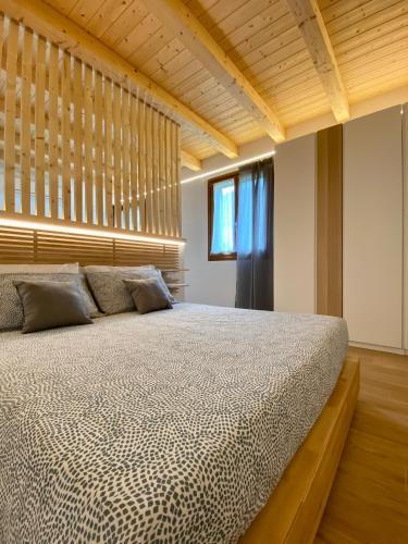 a bedroom with a large bed and a window at MARCO APARTMENTS di Locanda da Marco in Pignone