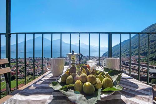 a plate of fruit on a table with a view at Crotto Palma in Dongo