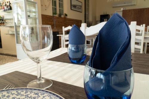 a table with two wine glasses and blue napkins at Casa Pinha in Figueira da Foz