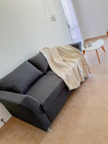 a couch with a blanket on top of it in a room at Alquiler Temporario Santa Fe in Santa Fe