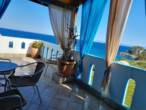 a balcony with a view of the ocean at Delfini in Akhladherí
