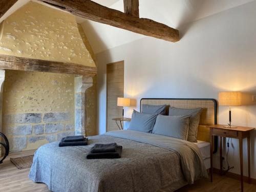 En eller flere senge i et værelse på Chambres d'hôtes du Bistrot des écuries