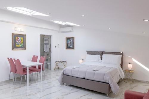 a bedroom with a bed and a table and chairs at Royal Boutique Napoli in Naples