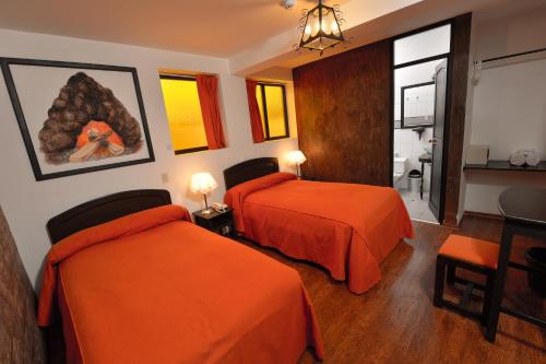 Ein Bett oder Betten in einem Zimmer der Unterkunft Tika Wasi Casa Boutique