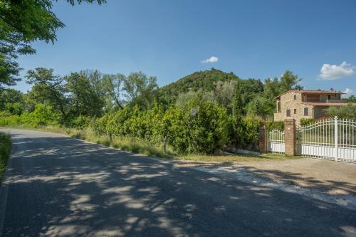 an empty road with a fence and a building at Borgo da Vinci in Volterra