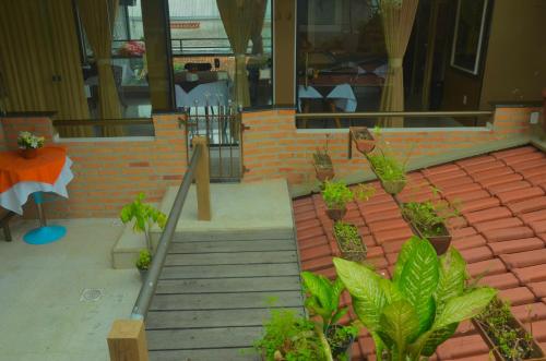a set of stairs with potted plants in front of a building at Studio Bangalô Belém Hospedagem in Belém