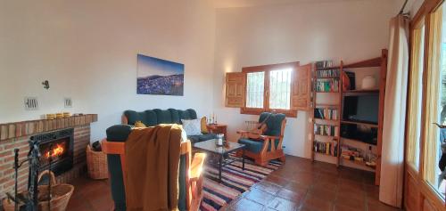 a living room with a couch and a fireplace at Finca Casa Emilia in Cómpeta