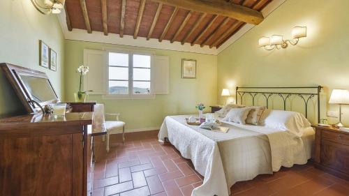 een slaapkamer met een bed, een ladekast en een raam bij Pesci in Gaiole in Chianti
