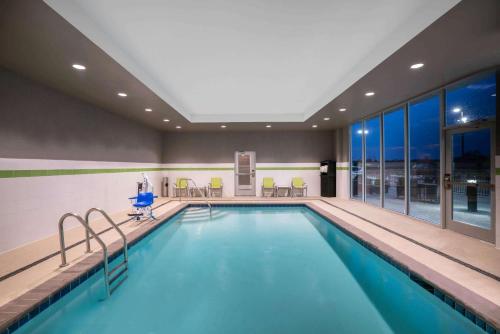 a swimming pool in a hotel room with a large window at La Quinta by Wyndham West Memphis in West Memphis