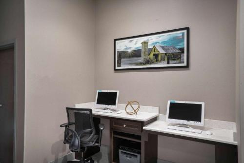 two computers are sitting on a desk in a room at La Quinta by Wyndham West Memphis in West Memphis