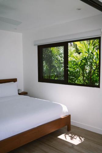 1 dormitorio con cama y ventana grande en Sky House Santa Teresa - Adults only, en Santa Teresa Beach