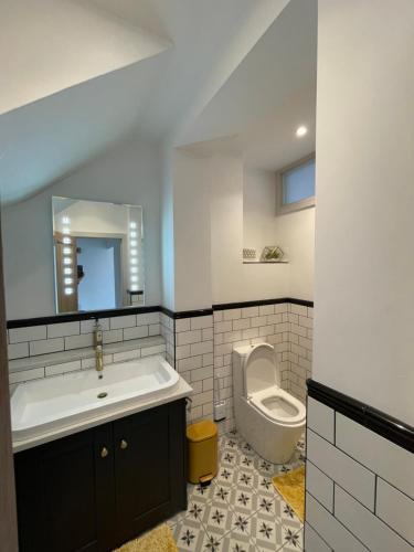 a bathroom with a sink and a toilet at Lees Lookout Holt ,2 bedroom luxury apartment with private parking in Holt
