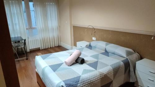 a bedroom with a bed with a pillow on it at Casa acogedora in Mundaka