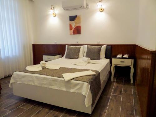 a bedroom with a bed with two towels on it at Zulu Hotel in Kumluca