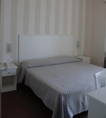 a bedroom with a bed and two night stands at Hotel Corallo in Villapiana