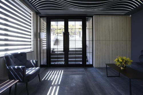 a lobby with a door and a chair and a table at Bourbon Boutique Hotel in Yerevan