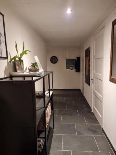 a hallway with a tiled floor and a door at De Schotse Hooglander in Smilde