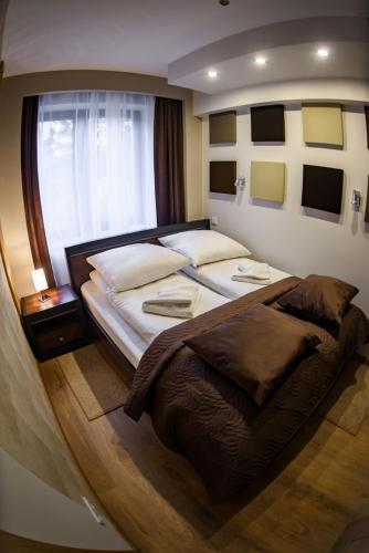 a bedroom with a large bed and a window at Zielony Zdrój 105 in Krynica Zdrój