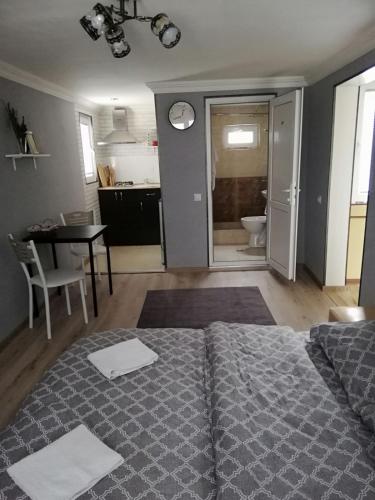 een slaapkamer met een bed en een tafel en een keuken bij Lamara apartament in Tbilisi City