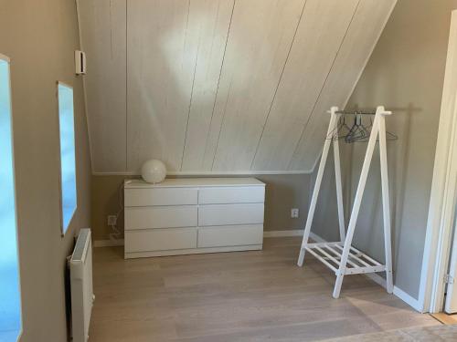 a room with a desk and a dresser and a ladder at Högklint by the Sea Apartment in Visby