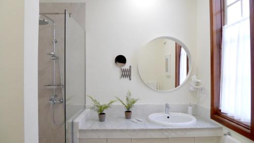 a bathroom with a sink and a mirror at Nava Suites in La Laguna