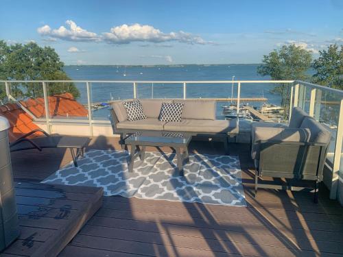 a balcony with a table and chairs on a boat at Apartament Masuria Sky w Nautica Resort z widokiem na jezioro Niegocin in Giżycko