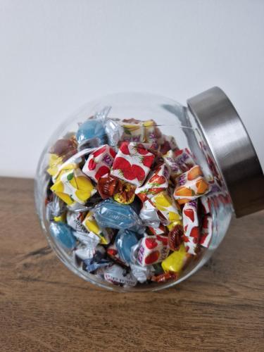 a glass jar filled with candy melts at BulevarD Apartment in Belgrade