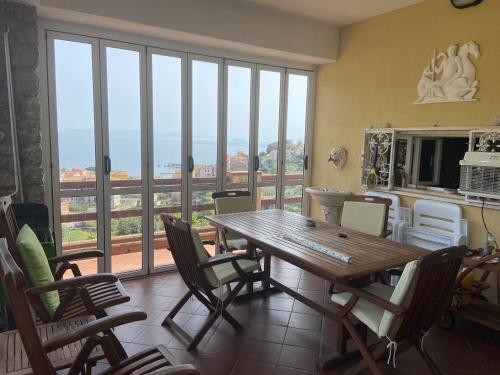a dining room with a wooden table and chairs at Villa Maurizio in Rio Marina