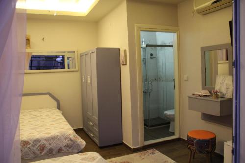 a bedroom with a bed and a shower and a toilet at Balim Sultany in Çeşme