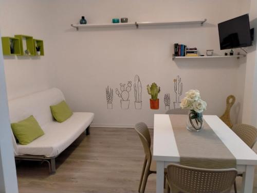 a living room with a couch and a table at Sea&Bike_Apartment in Finale Ligure