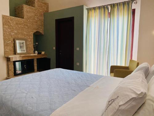 a bedroom with a large bed and a window at Gea Kaimaktsalan Hotel & Spa in Kato Loutraki