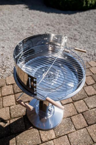 a grill sitting on top of a brick ground at La Fagne Fleurie Les Myrtilles en Les Camomilles in Vielsalm