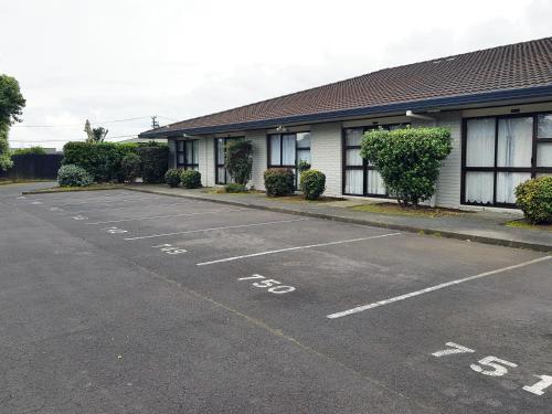 an empty parking lot in front of a building at Auckland Airport Easy Hotel in Auckland