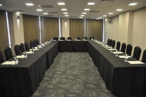 a row of tables in a room with chairs at CONNECT THERMAL HOTEL in Ankara