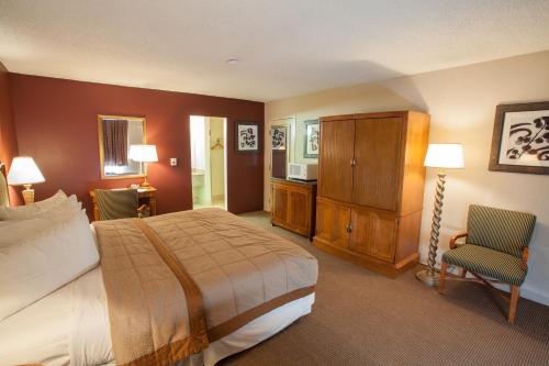 1 dormitorio con cama, escritorio y silla en Aviation Inn, en Las Vegas