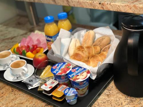 a tray of breakfast foods and drinks on a table at Holec Apartments in Prague