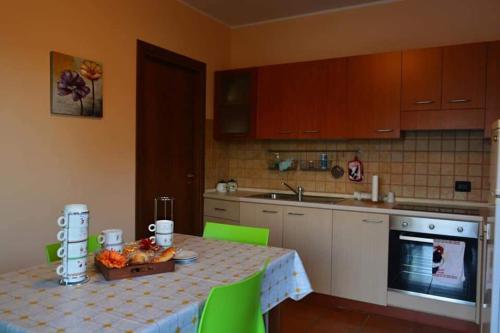 a kitchen with a table with a bowl of fruit on it at Azienda Agricola Cuntarati in Bronte