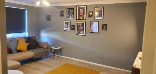 a living room with a couch and pictures on the wall at The Court in Braintree