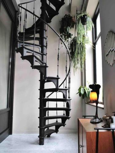 a black spiral staircase in a living room at Boutique B&B in Edam in Edam