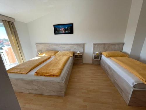 two beds in a room with a window at VILLA NIKOLINA in Medulin