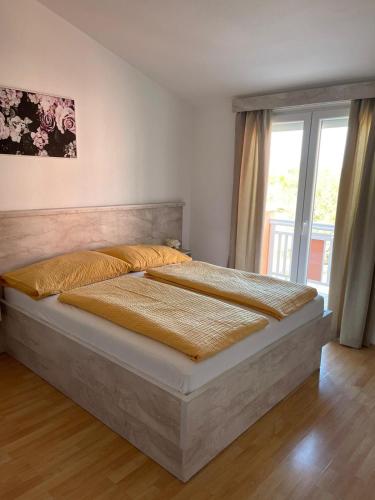 two beds in a bedroom with a window at VILLA NIKOLINA in Medulin