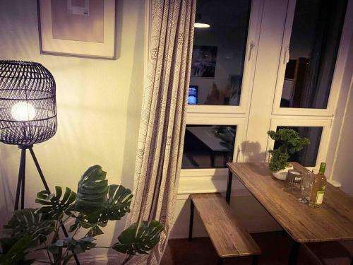 a room with a table and a window with plants at Entire Stylish 1 Bedroom Flat with Free Parking in Dundee