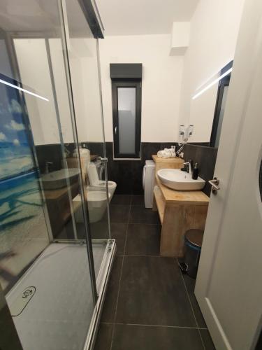 a bathroom with a shower and a toilet and a sink at Camere Fiera Verona - CasaNostra in Verona