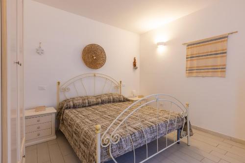 a bedroom with a bed and a clock on the wall at Leuca Mon Amour in Leuca